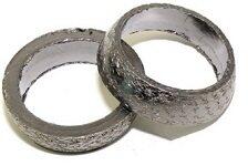 Two donut-shaped graphite exhaust gaskets are shown on a white background, suitable for use in an exhaust system seal.