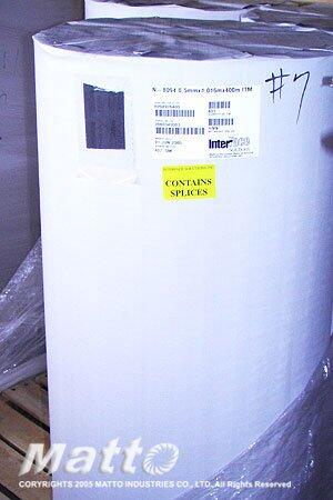 A large, white industrial roll of paper or similar material, labeled with "Matto Industries Co, LTD" and indicating "CONTAINS SPLICES" on a yellow sticker, along with the number "#7" and an "Inter" logo.