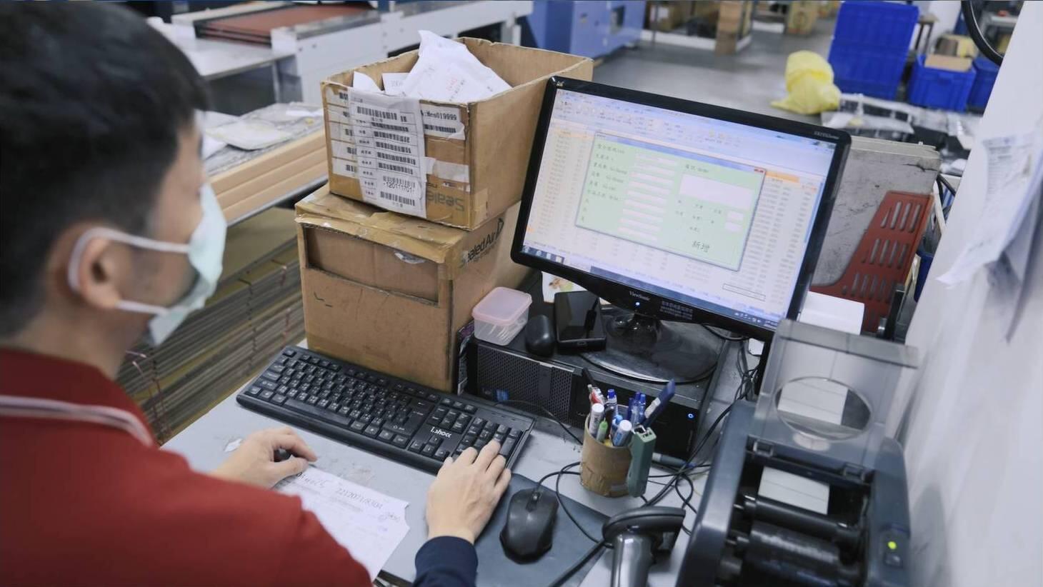 Employee working at a computer in a warehouse